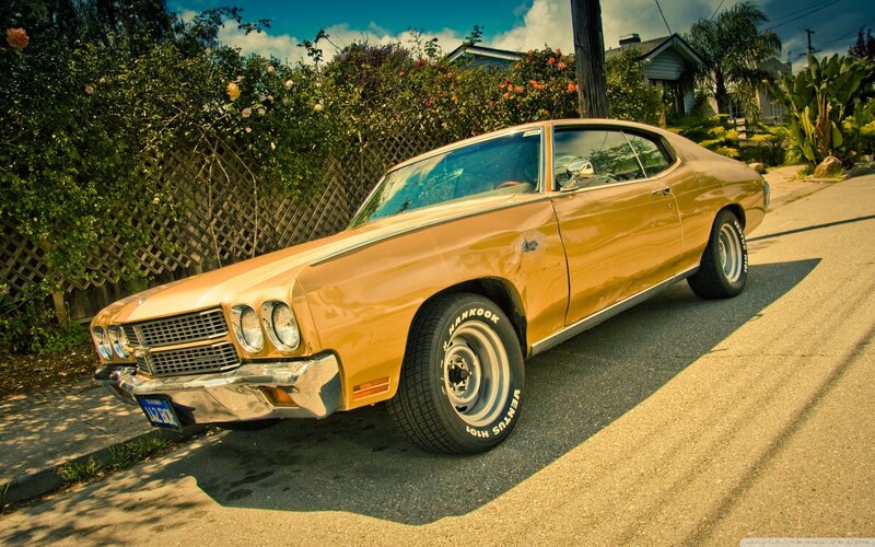 Classic orange muscle car on street
