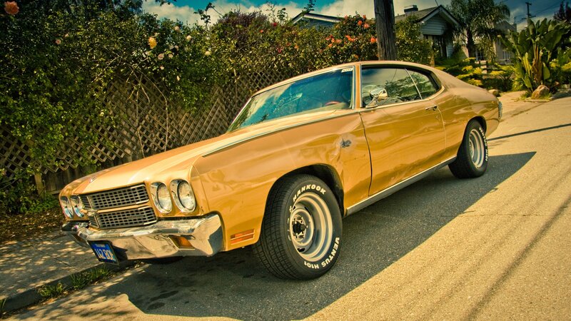 Classic orange muscle car on street