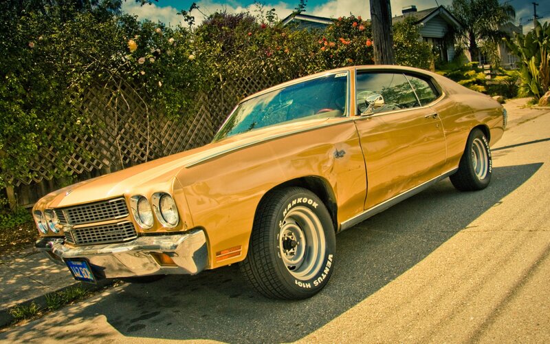 Classic orange muscle car on street