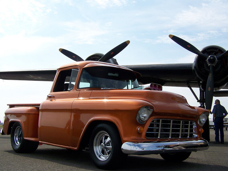 Classic orange pickup truck at airshow