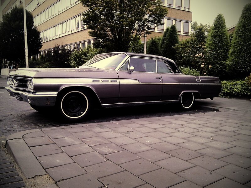 Classic purple car on a city street