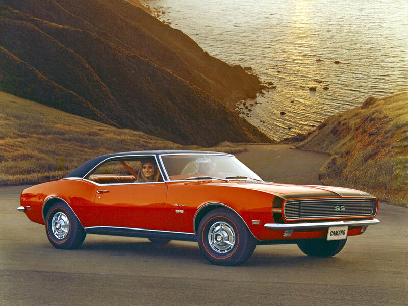 Classic red Camaro on coastal road