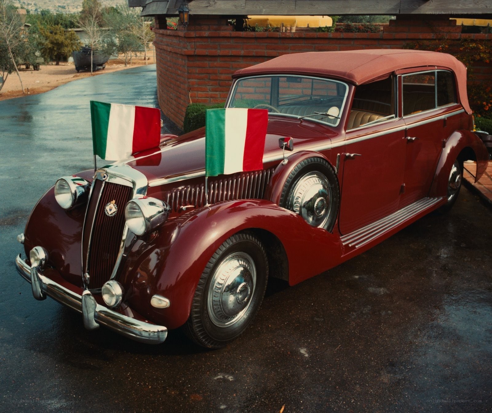 Classic red Italian car with flags