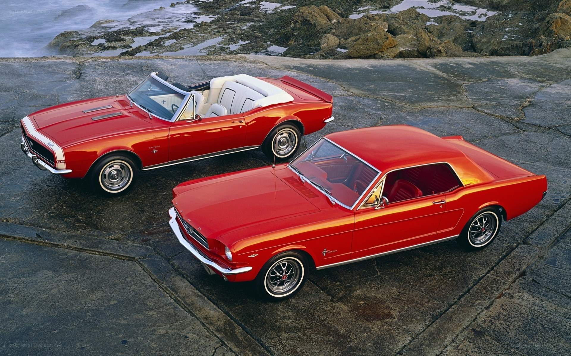 Classic red muscle cars by the coast