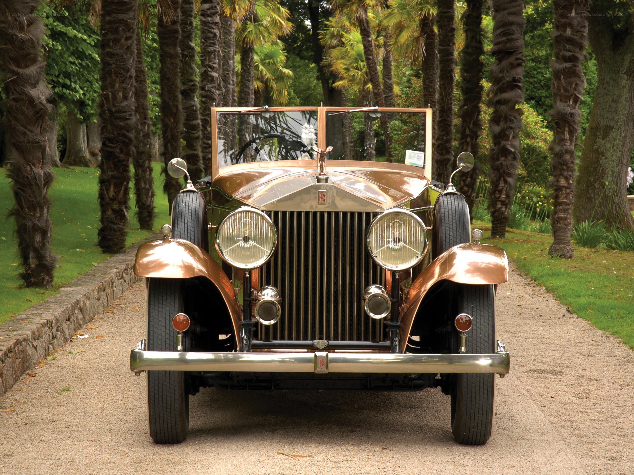Classic Rolls-Royce on a tree-lined path