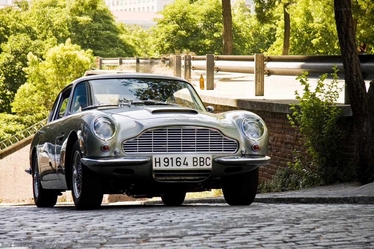 Classic silver Aston Martin on cobblestones