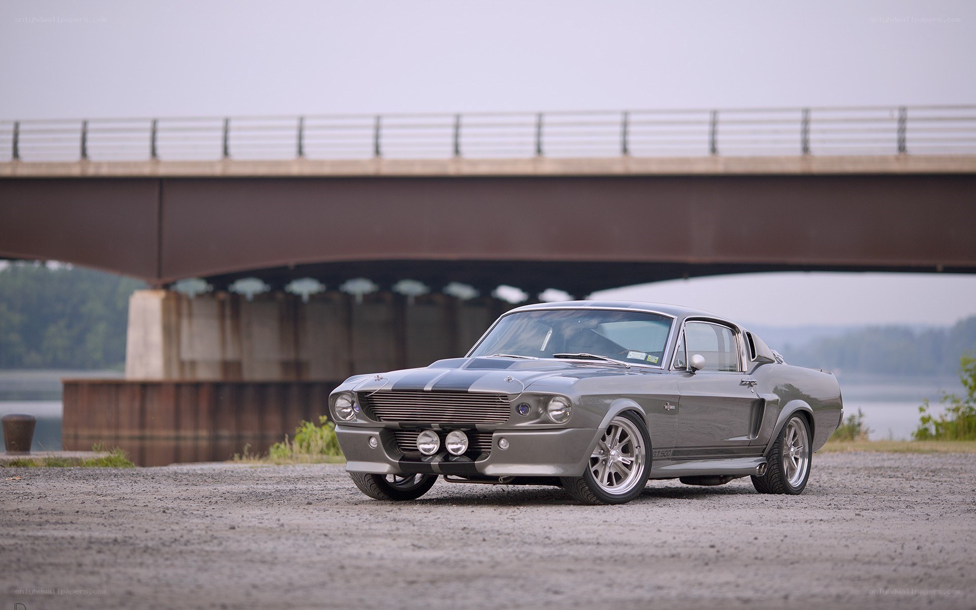 Classic silver muscle car under bridge