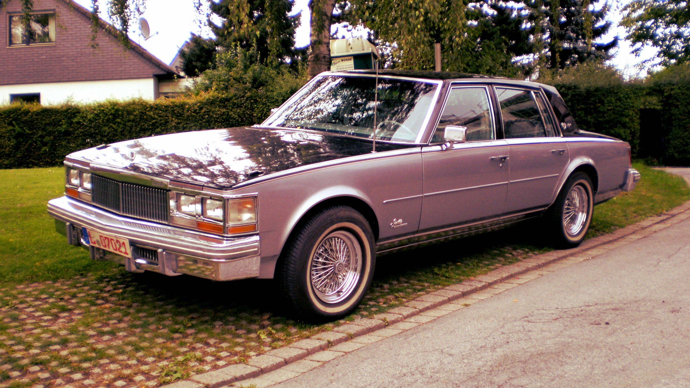 Classic silver sedan parked outside