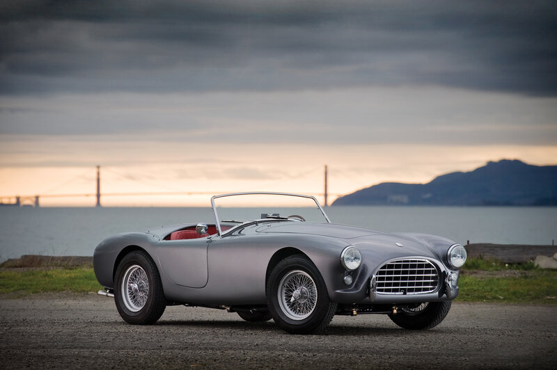 Classic silver sports car by the water