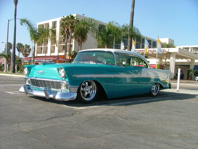 Classic teal car in parking lot