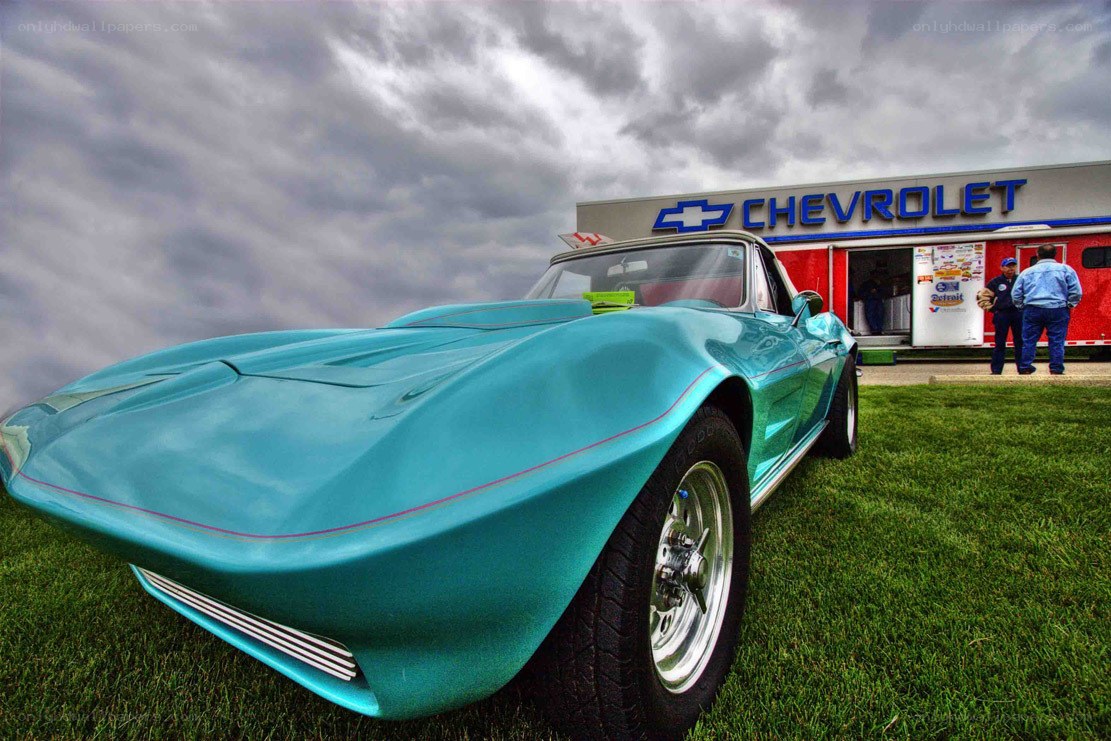 Classic teal Corvette at a car show