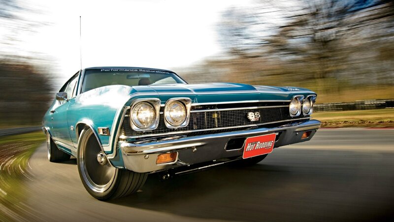 Classic teal muscle car in motion