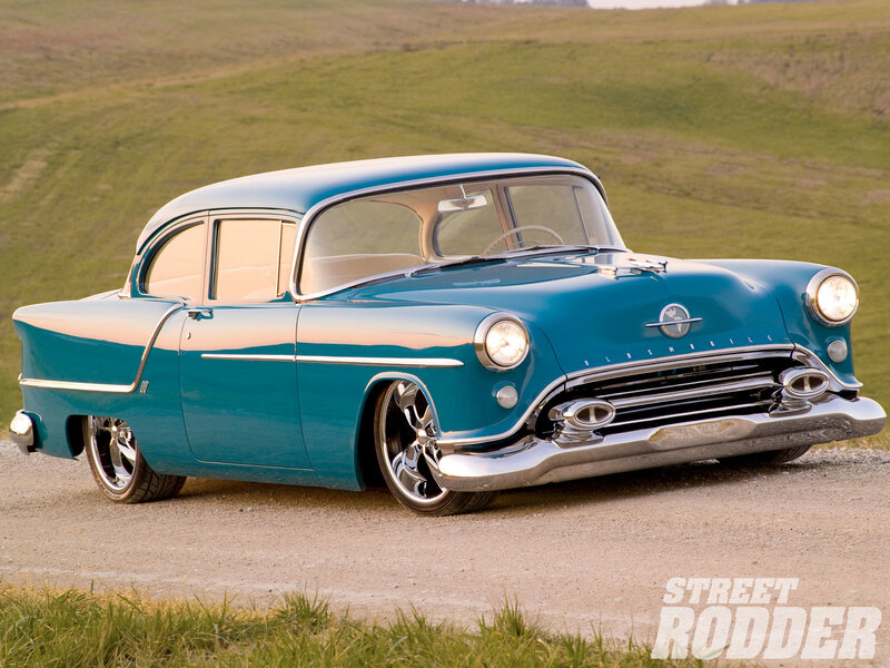 Classic teal Oldsmobile on a country road