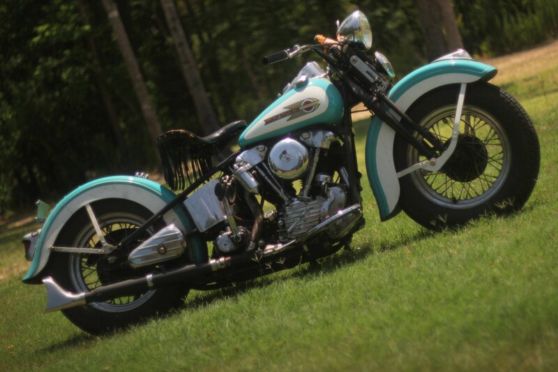 Classic turquoise motorcycle on grass