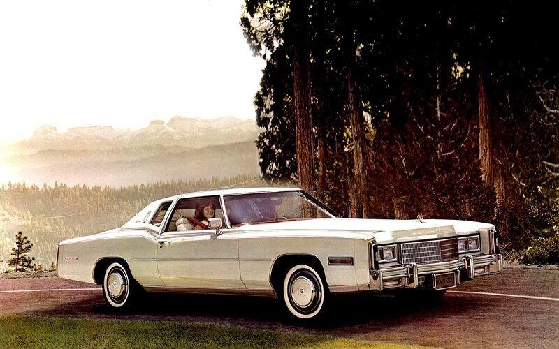 Classic white Cadillac on a mountain road