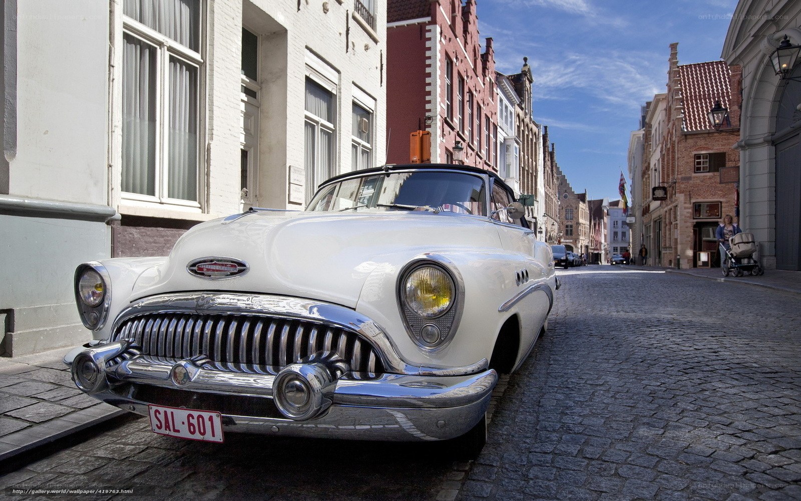 Classic white car on cobblestone street