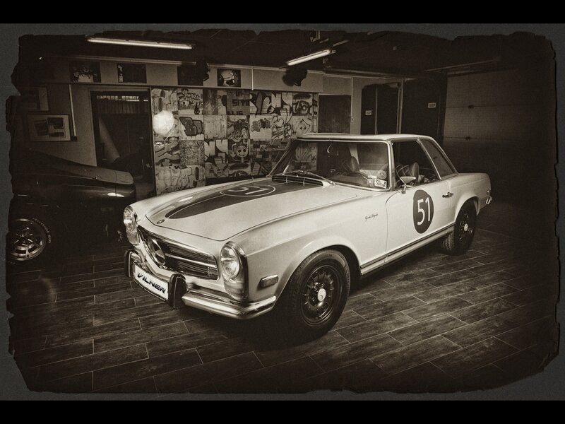 Classic white race car in garage