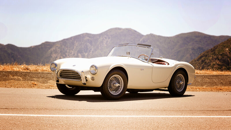 Classic white sports car on road