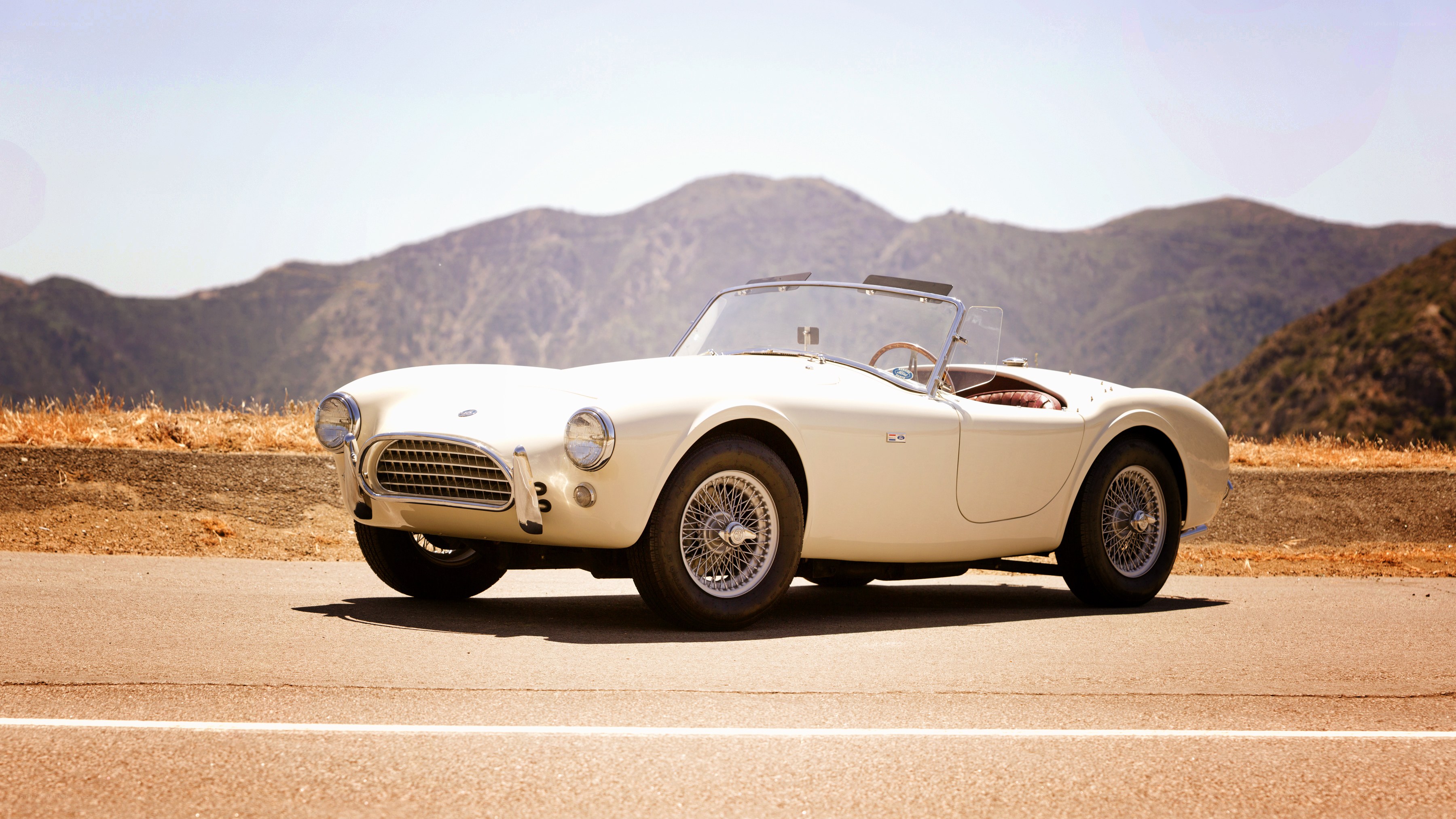 Classic white sports car on road