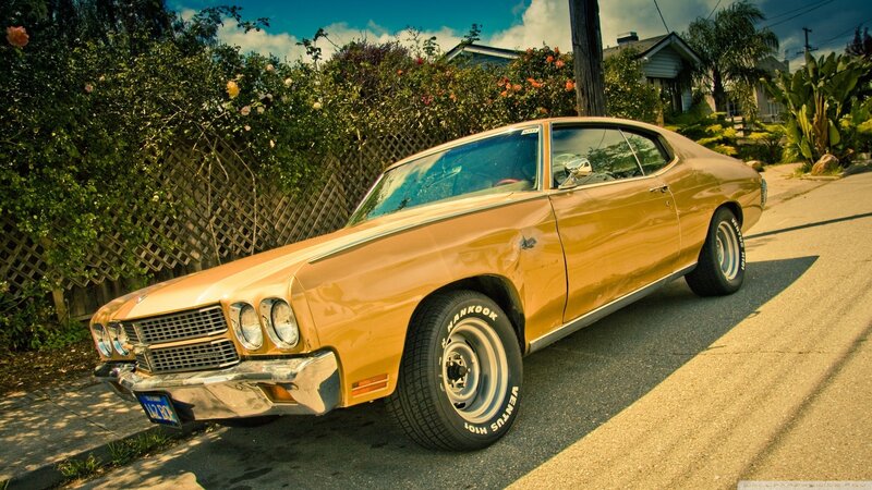 Classic yellow muscle car on street