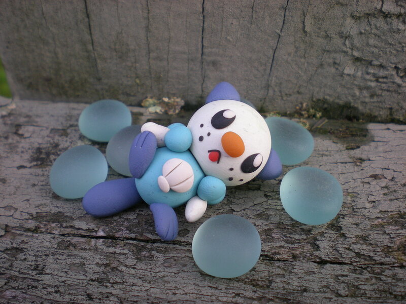 clay snowman figurine on wood