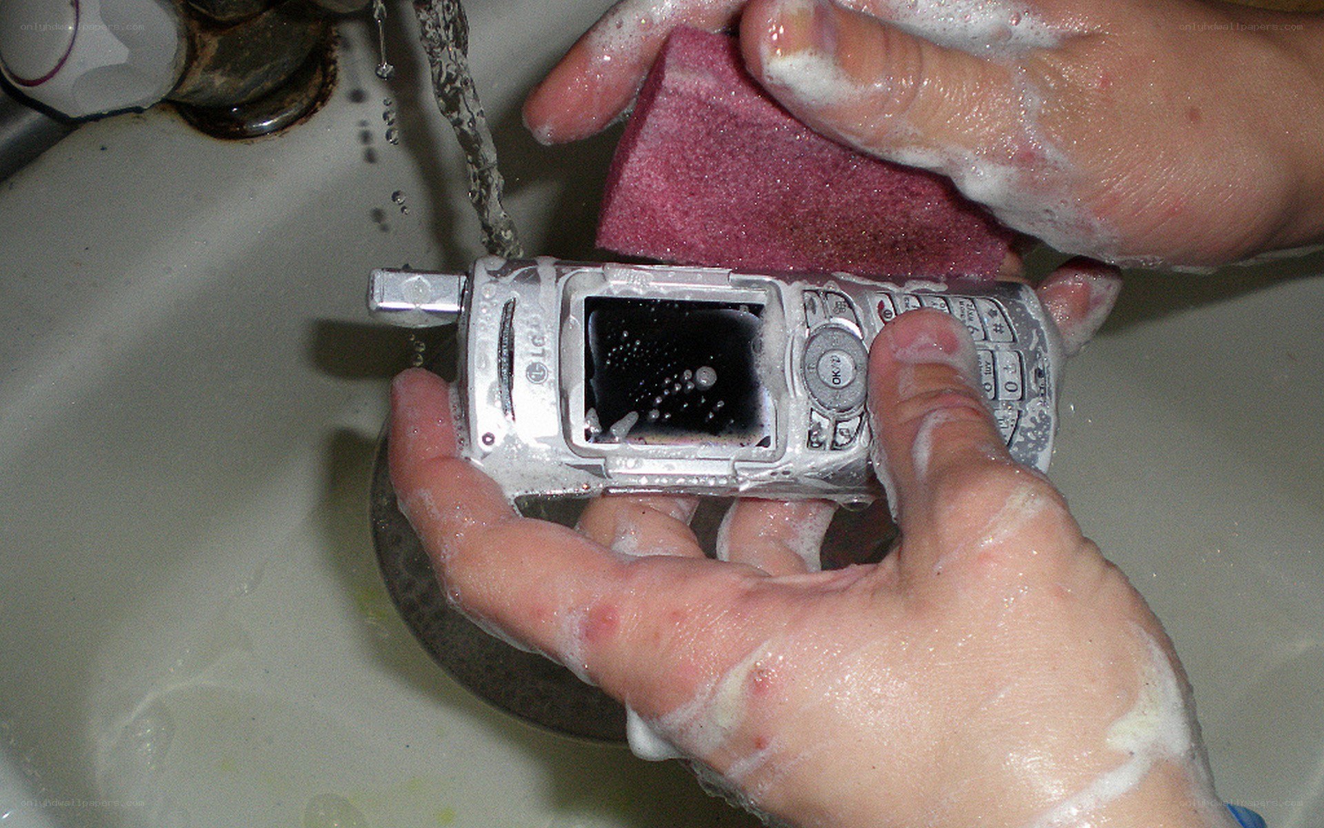 Cleaning a phone in sink