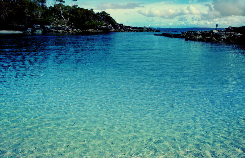 Clear blue cove with rocky shore