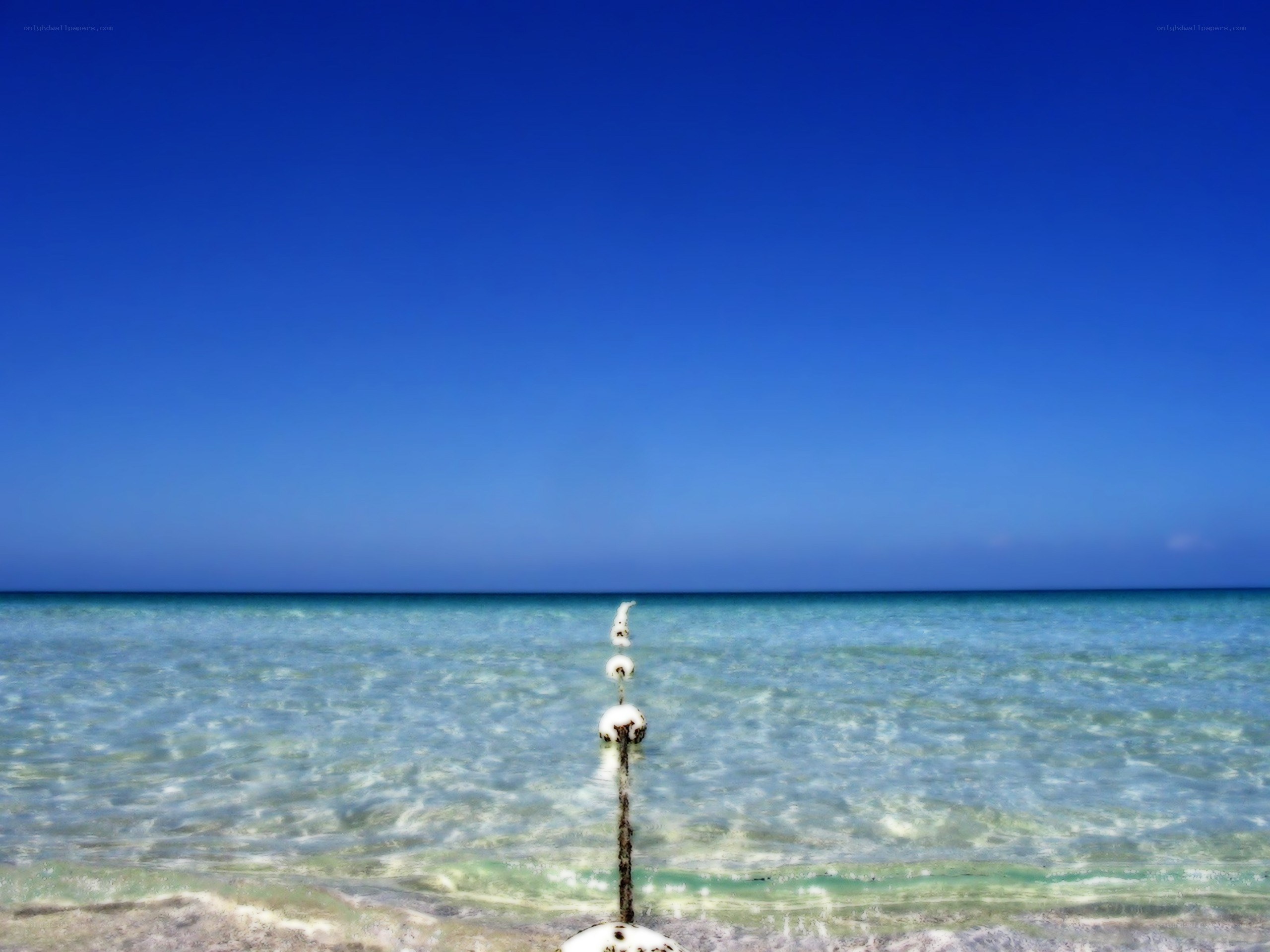 Clear blue ocean with buoy