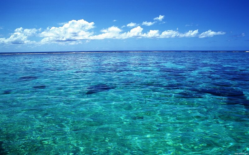Clear blue ocean with white clouds