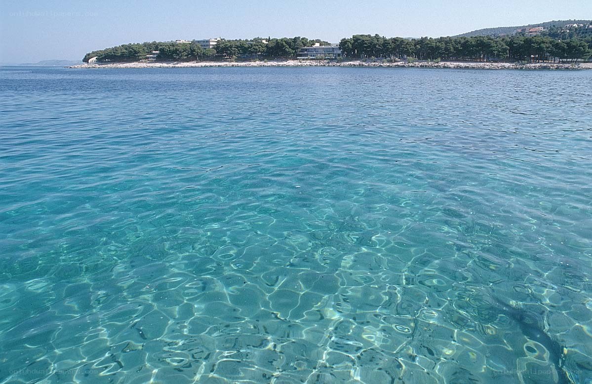 Clear blue sea with distant shore