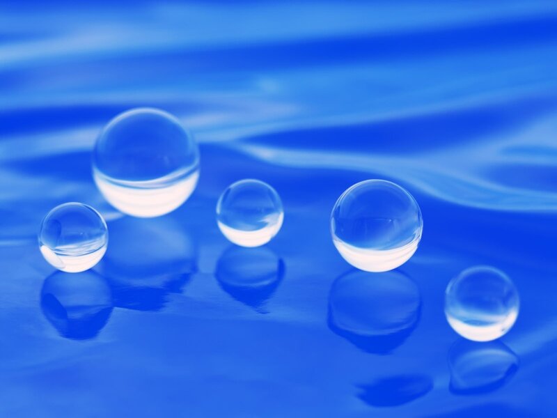 Clear glass spheres on blue surface