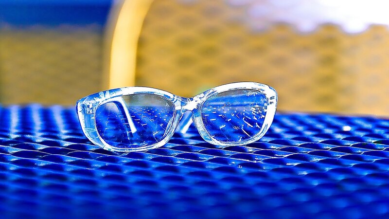 Clear glasses on blue surface