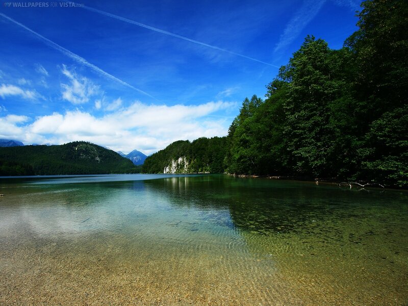 Clear lake with forest and mountains
