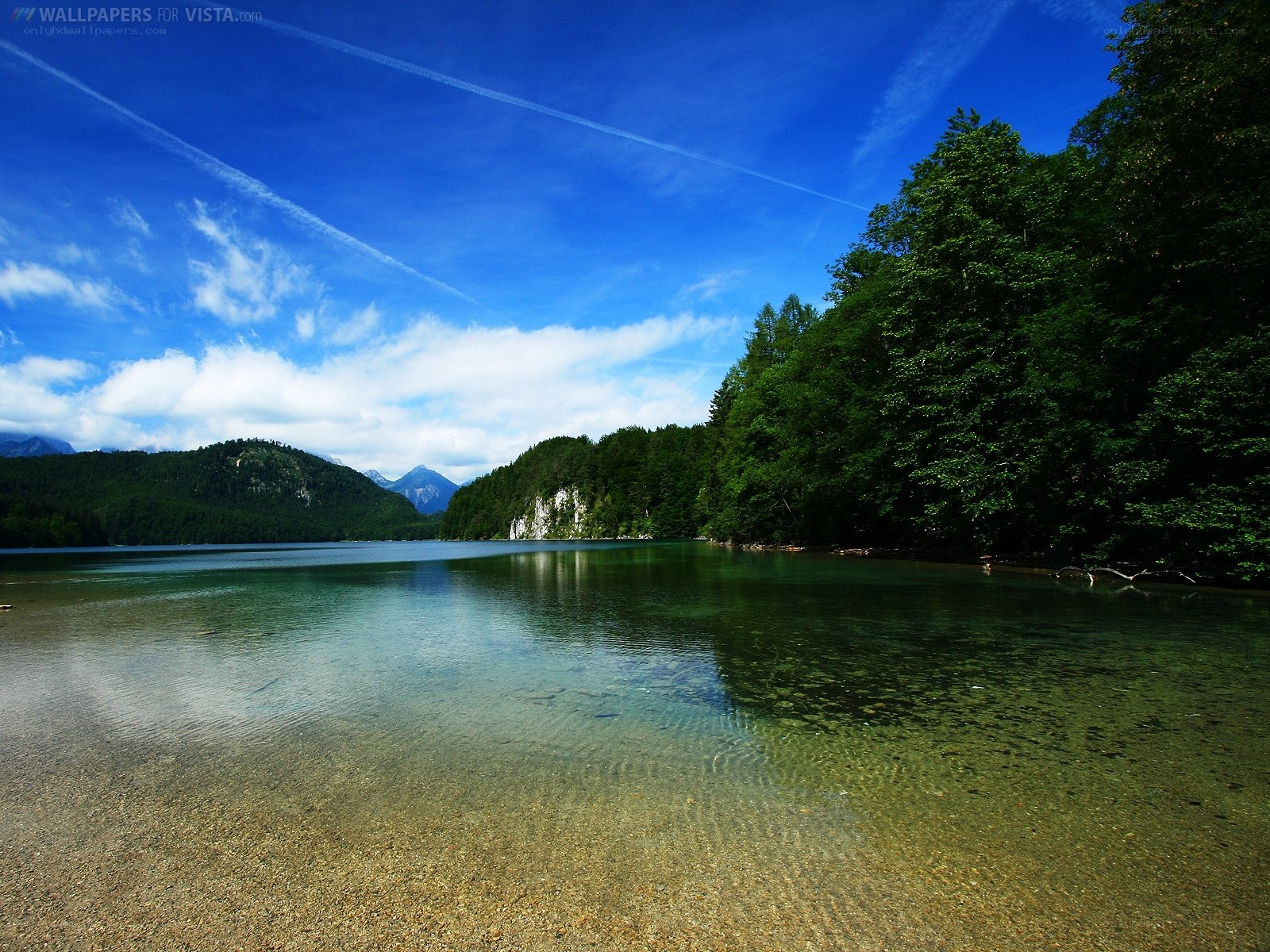 Clear lake with forest and mountains