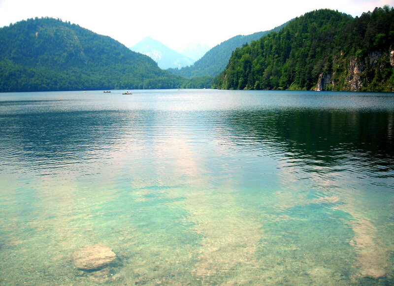 Clear lake with forested mountains