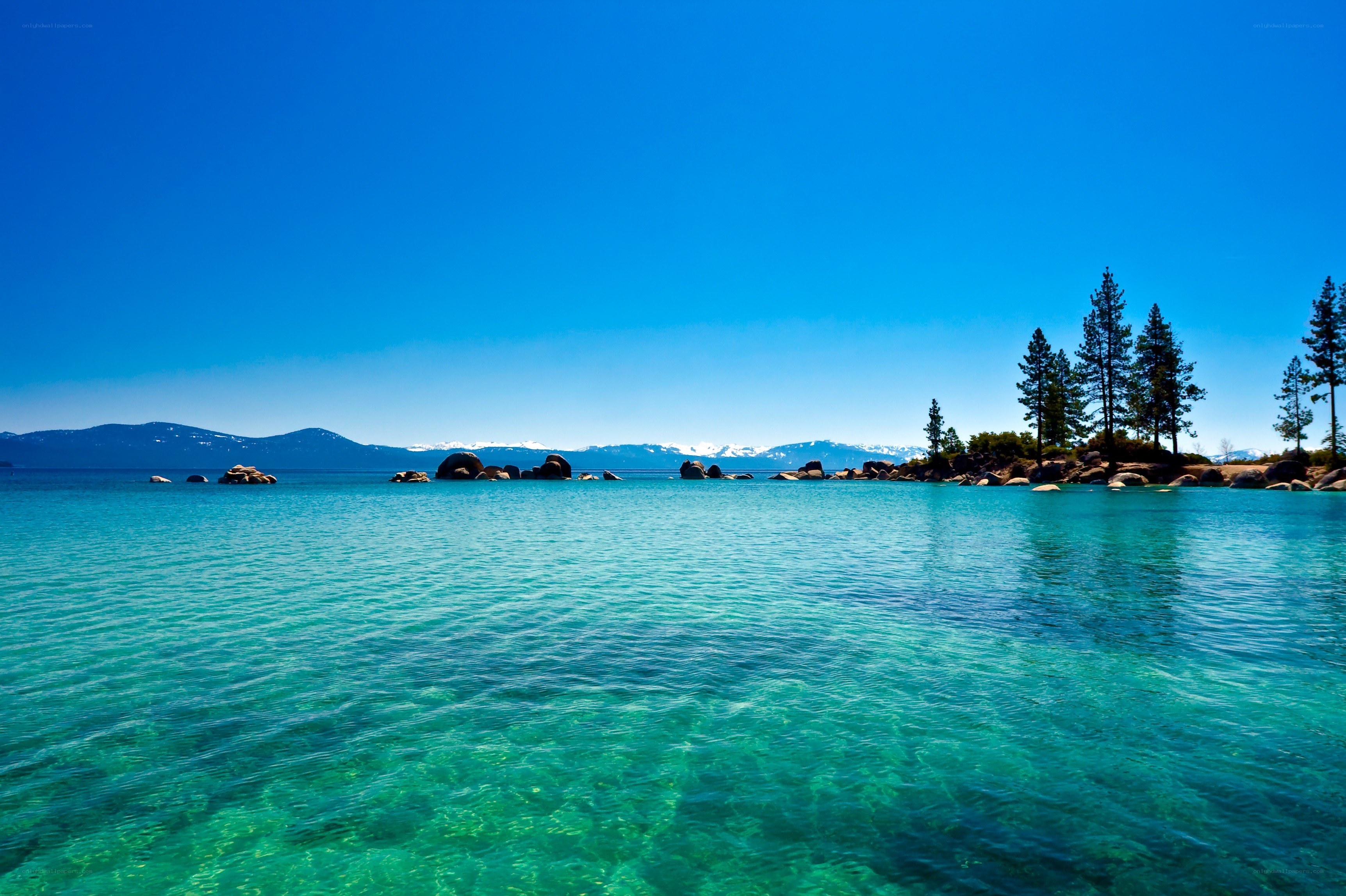 Clear lake with mountains in background