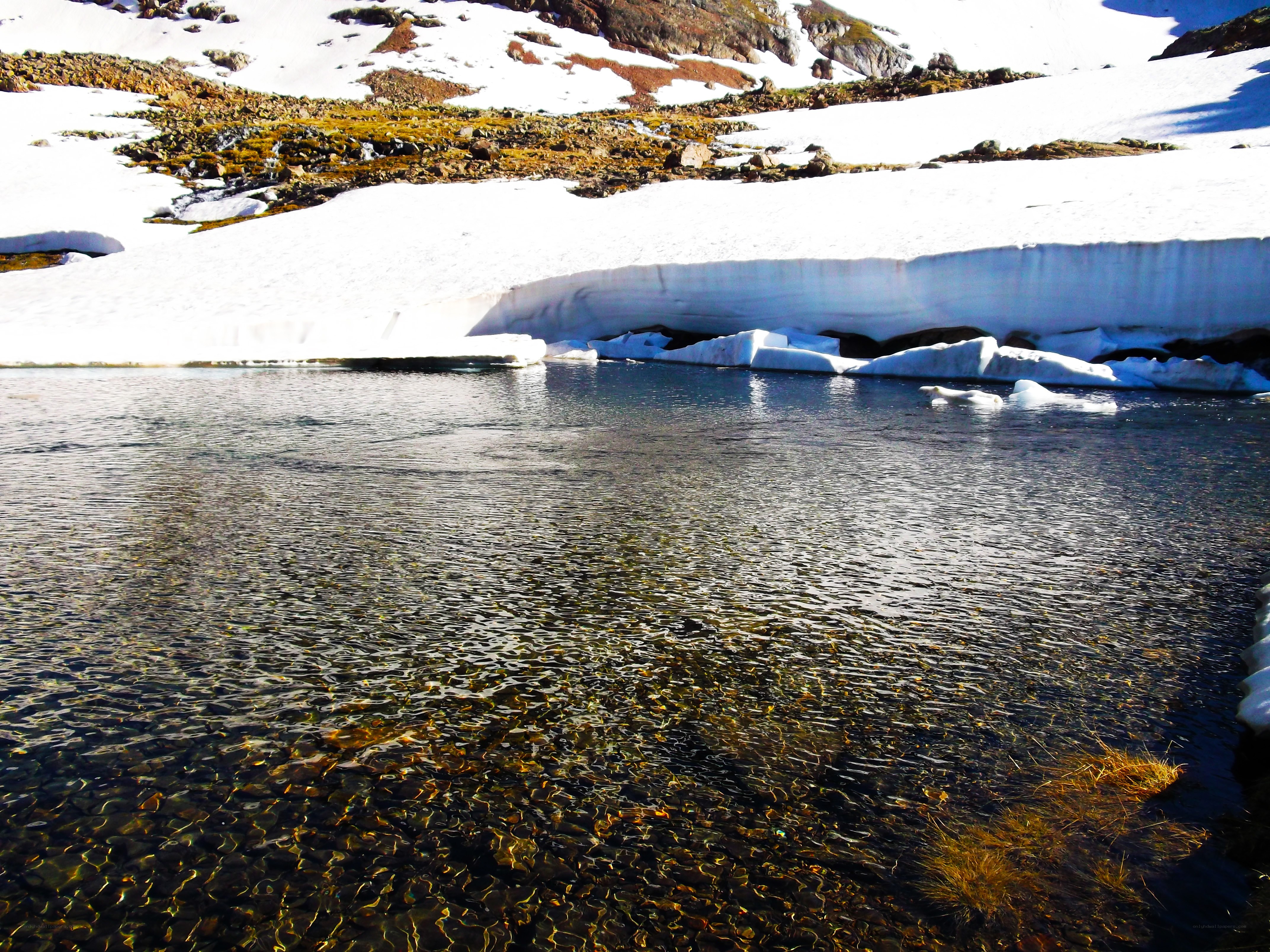 Clear lake with snow-covered mountains