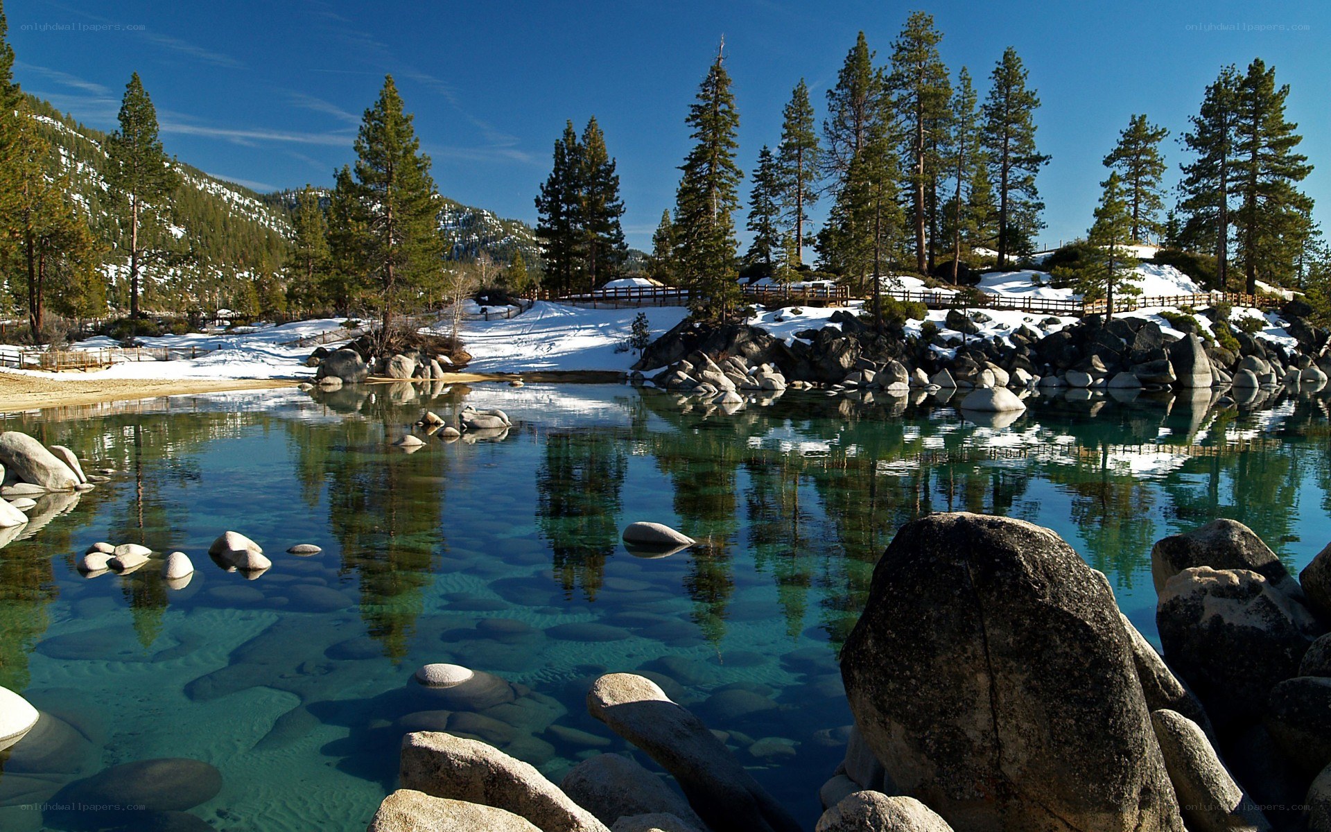 Clear lake with snowy mountains