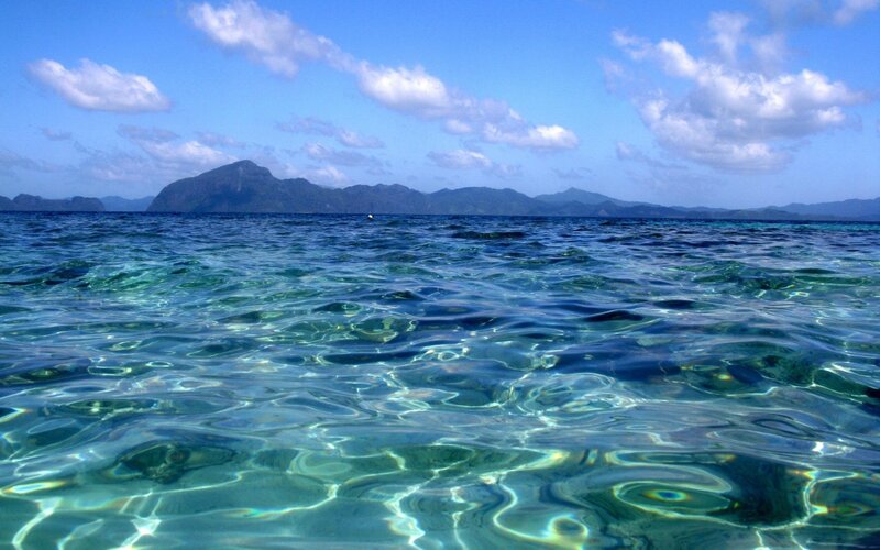 Clear ocean water with distant island