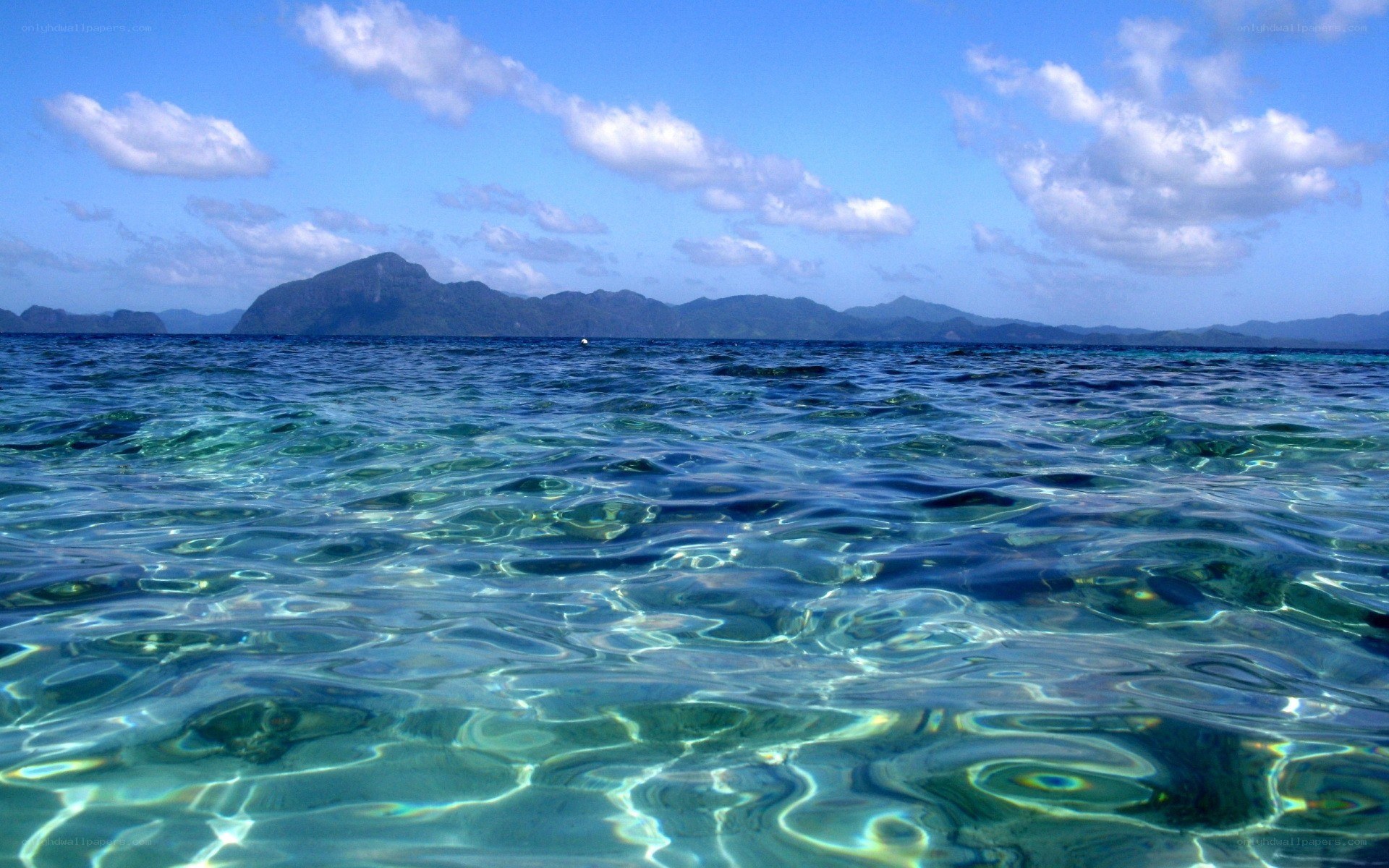 Clear ocean water with distant island