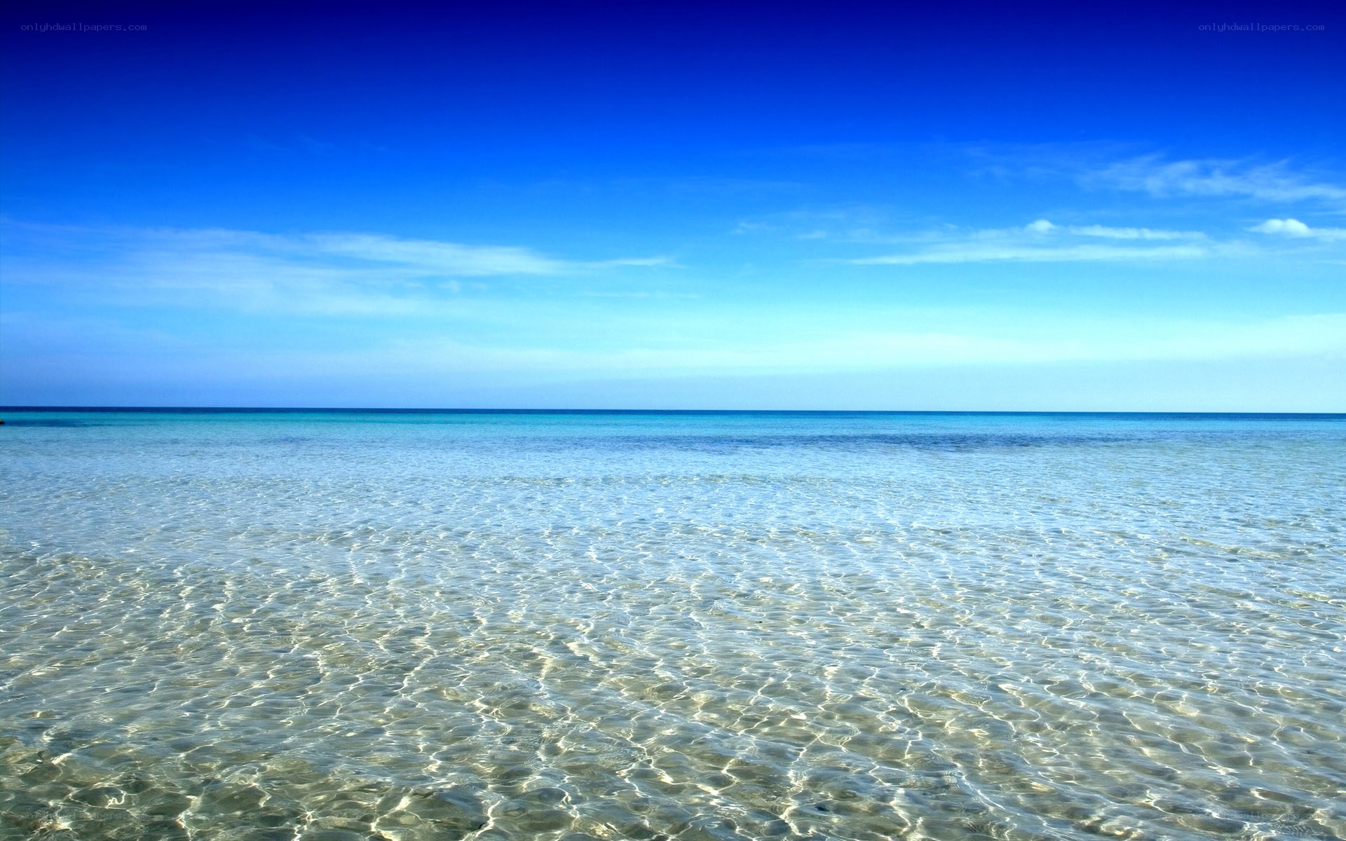 Clear ocean waters under blue sky