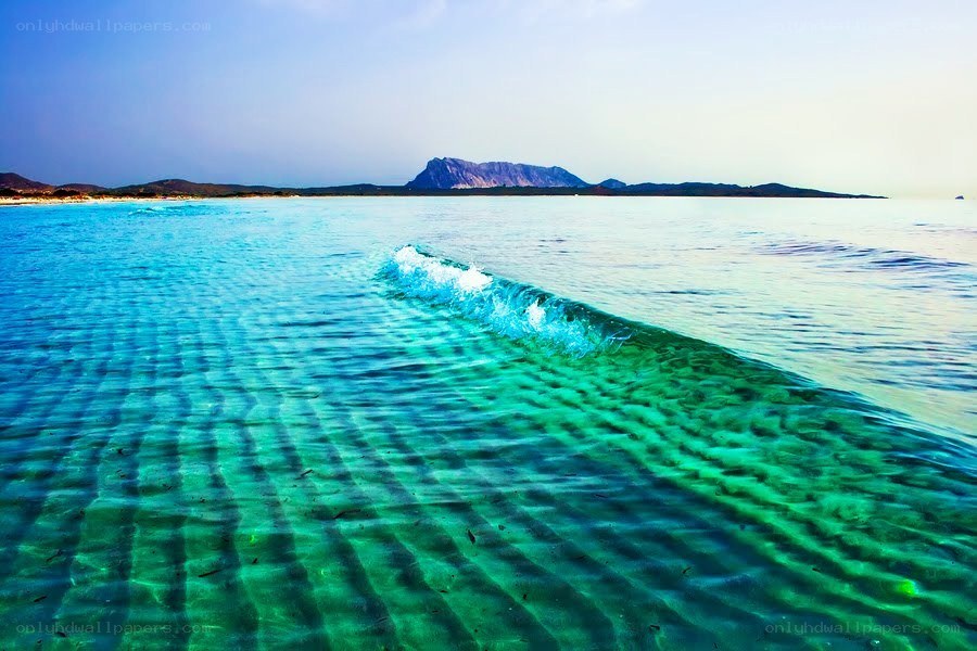 Clear ocean wave with mountain view