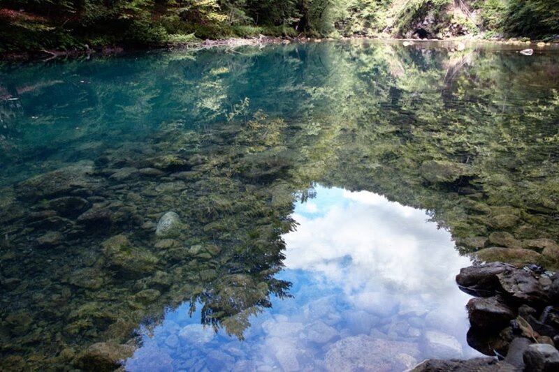Clear river reflecting sky and trees