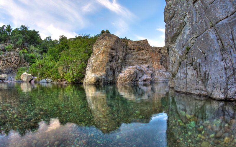 Clear river with rocky cliffs