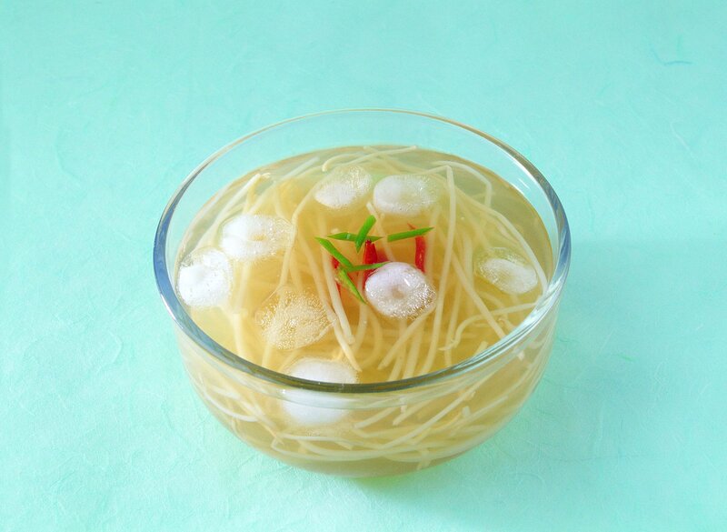 clear soup with noodles and garnish