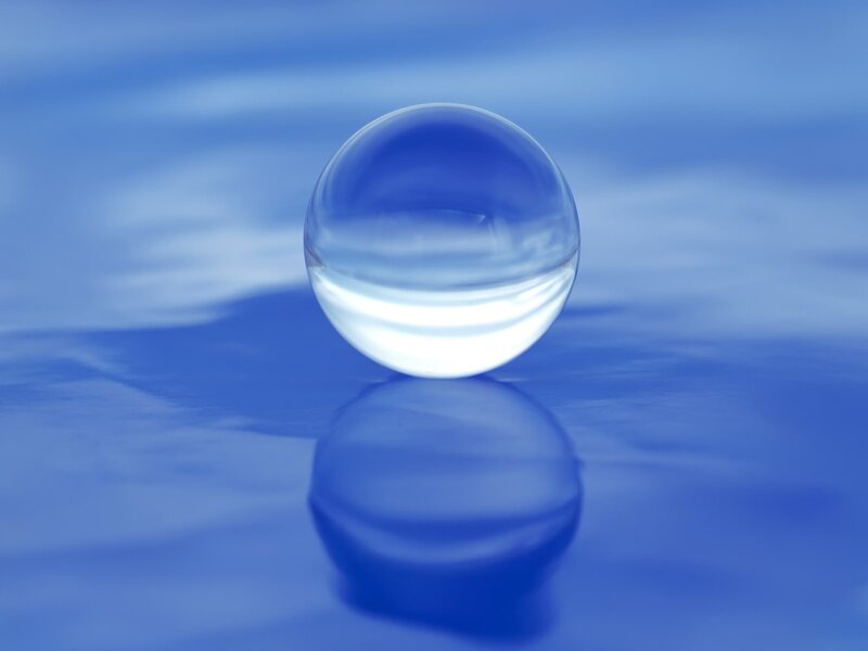 Clear sphere on blue surface
