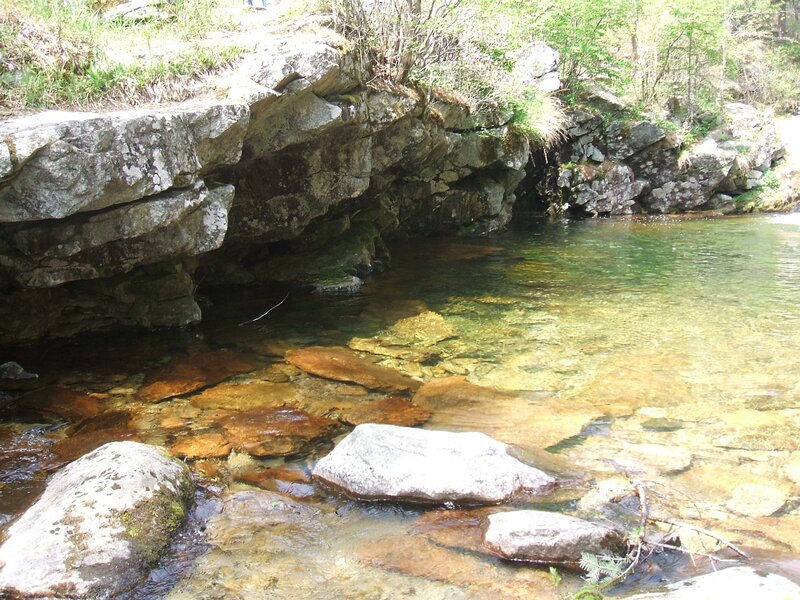 Clear stream under rocky overhang