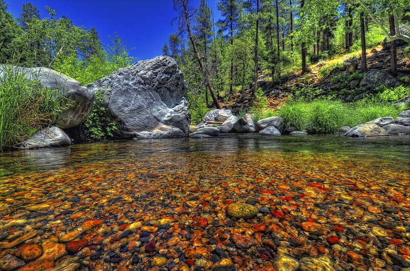 Clear stream with colorful pebbles