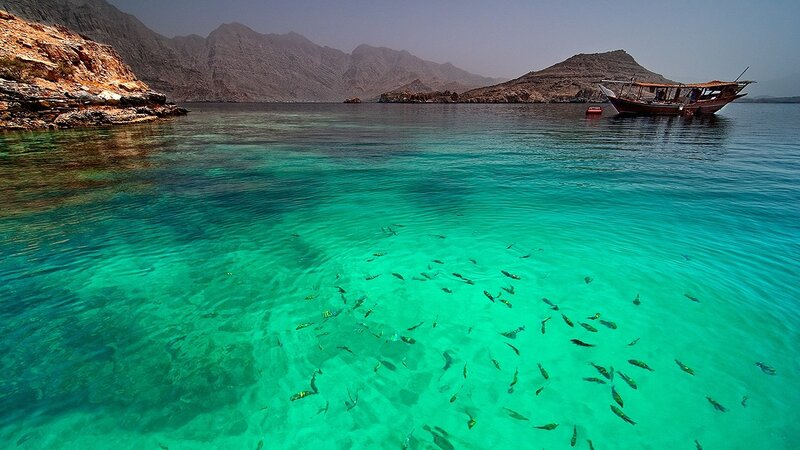 Clear turquoise water with fish and boat