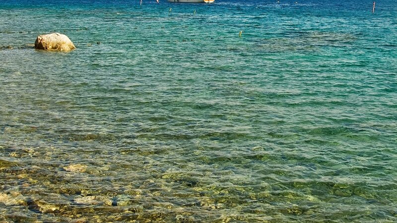 Clear turquoise water with rock